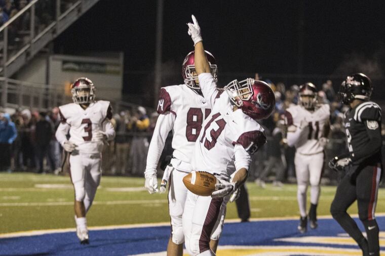 Marques Mason (center) of St. Jospeh’s’s Prep celebrates after his second quarter touchdown against Coatesville at Downingtown West in a PIAA Class 6A semifinal on Friday.