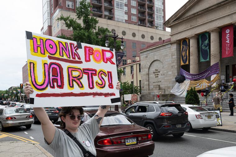 University of the Arts film student Danni Seidel holds a sign protesting the school's closure outside Hamilton Hall in Philadelphia on Thursday.