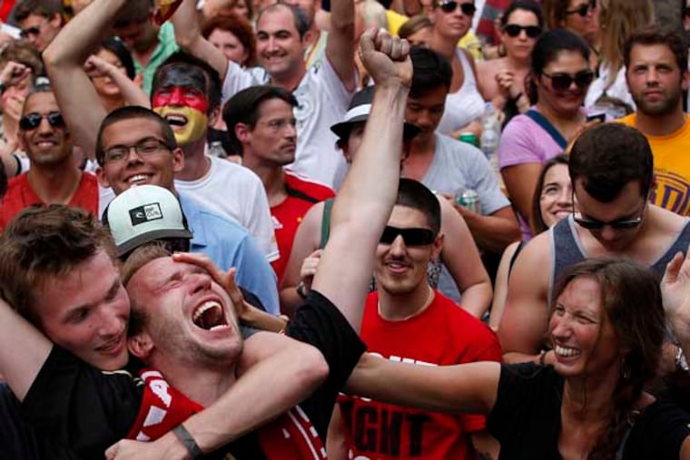 Daniel Witt (center leaning back) celebrates Germany's win. Soccer fans watch Germany and Argentina in the World Cup Final on a giant screen in the closed off block on South Street between 7th and 8th Steets during a festival thrown by Brahaus Schmitz. ( MICHAEL S. WIRTZ / Staff Photographer ) July 10, 2014