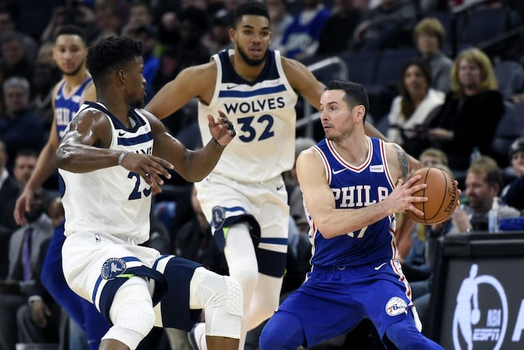 Jimmy Butler and Karl-Anthony Towns (32) guard JJ Redick (17) during the Philadelphia 76ers’ 118-112 overtime win at the Minnesota Timberwolves.