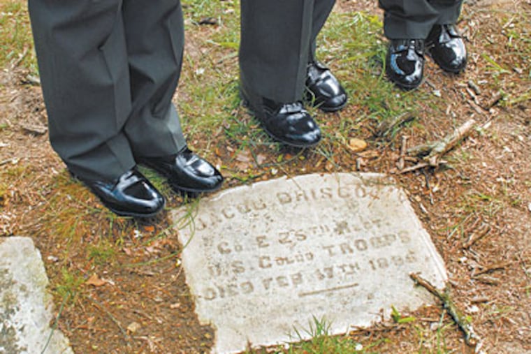 Dozens of gravestones were uncovered at a historic African American cemetery by students cleaning up a Camden park. (TOM GRALISH / Staff Photographer)