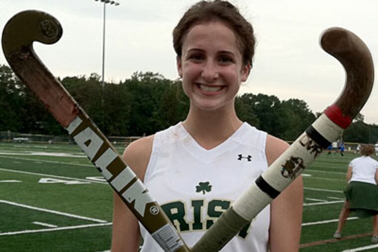 Camden Catholic's Tara Vittese compares her mother's field hockey stick (right) with her own. (Bill Iezzi/Staff)