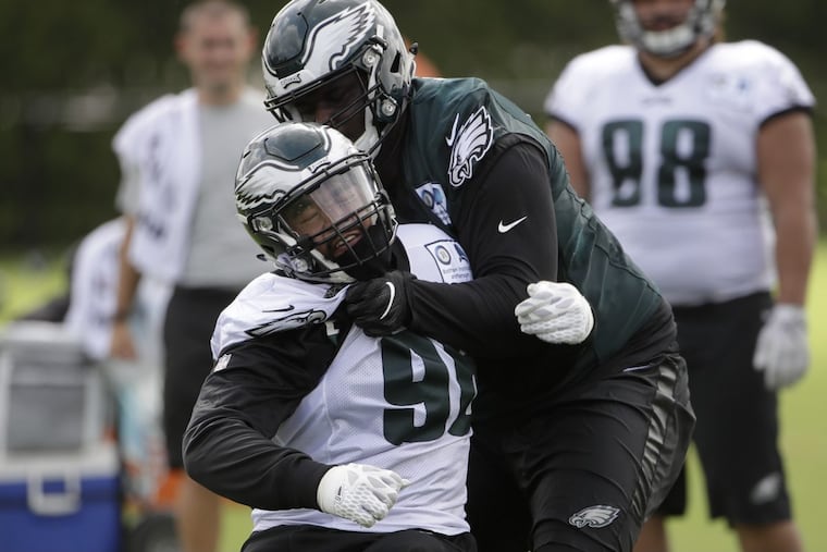 Philadelphia Eagles defensive end Derek Barnett (left) and offensive guard Dillon Gordon during training camp Monday.