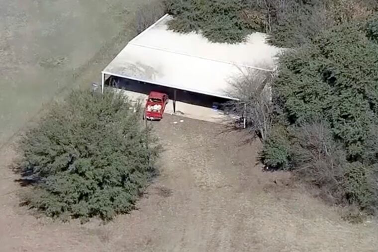 This aerial image provided by KDFW-FOX4 News shows part of the property where deputies found two young, malnourished children locked together in a dog cage near Rhome, Texas, about 20 miles northwest of Fort Worth. (AP Photo/KDFW-FOX4 News)