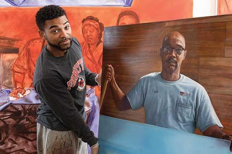 Mario Moore holds a painting he created for Princeton University.