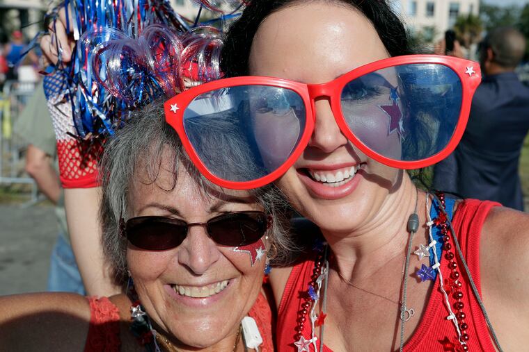 Judy Chastain, left, and Misty Gencarelle dance around as they wait in line to attend a campaign rally for President Donald Trump, Tuesday, June 18, 2019, in Orlando, Fla. (AP Photo/John Raoux)