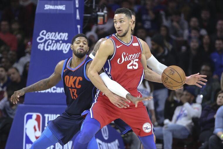 Thunder forward Paul George reaches in on Ben Simmons for the ball during the third quarter at the Wells Fargo Center.