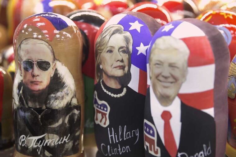Traditional Russian wooden dolls called Matreska depicting from left, Russian president Vladimir Putin and US presidential candidates Hillary Clinton and Donald Trump are displayed in a shop in Moscow, Russia on Tuesday, Nov. 8, 2016. Tens of millions of voters across the United States will now decide on the next occupant of the White House as polling stations open across the country. (AP Photo/Pavel Golovkin)