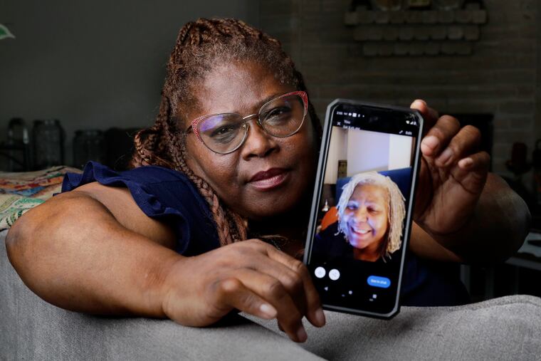 Janet Jarrett shows a photo of her sister, Pamela Jarrett, she keeps on her phone at the home they shared in Spring, Texas. Pamela Jarrett passed away after suffering heat related distress due to the power outage caused by hurricane Beryl.