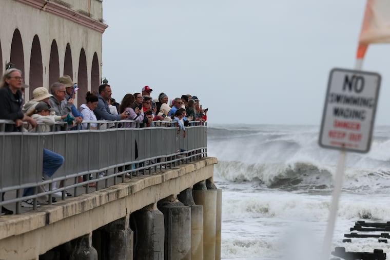 Onlookers gather to watch the rough surf at the Music Pier Thursday, Aug. 21, 2025, in Ocean City, N.J.