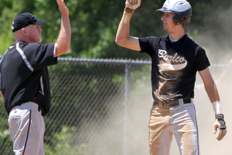Gary Herron congratulates Shane Garrett of Burlington County after his two-run triple. (Charles Fox / Staff Photographer)