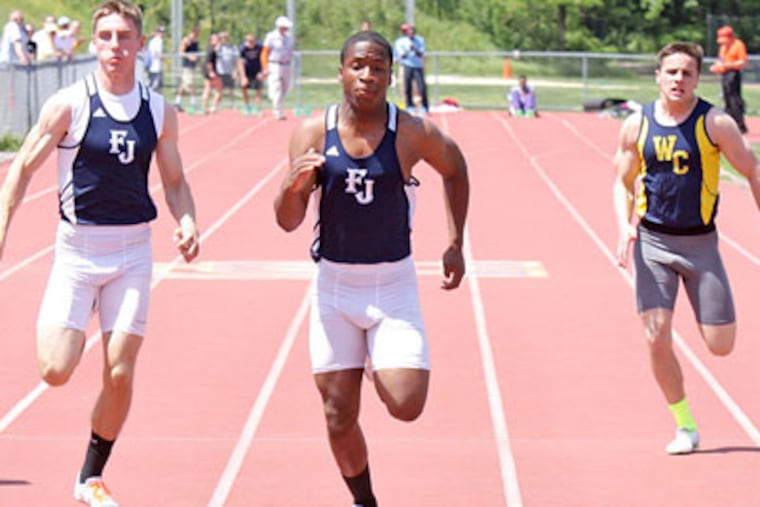 Father Judge's Matt Smalley (center) runs to victory in 10.86 seconds in the 100-meter dash. (Lou Rabito/Staff)