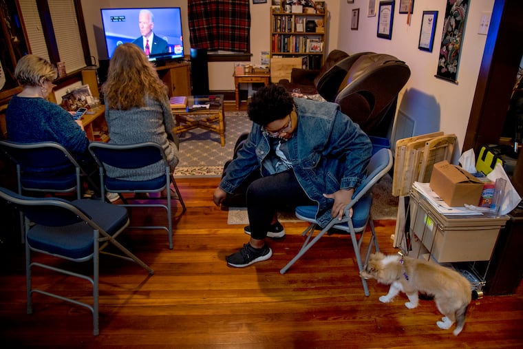 Joe Biden supporter Sydni Young of Woolwich plays with Merida, a 14 week old Shetland sheepdog puppy while at a Democratic presidential candidates debate watch party hosted by Bill Mead (not shown) at his Woodbury, N.J. home October 15, 2019. The former Vice President's high polling numbers contradiction the lack of enthusiasm for his campaign.