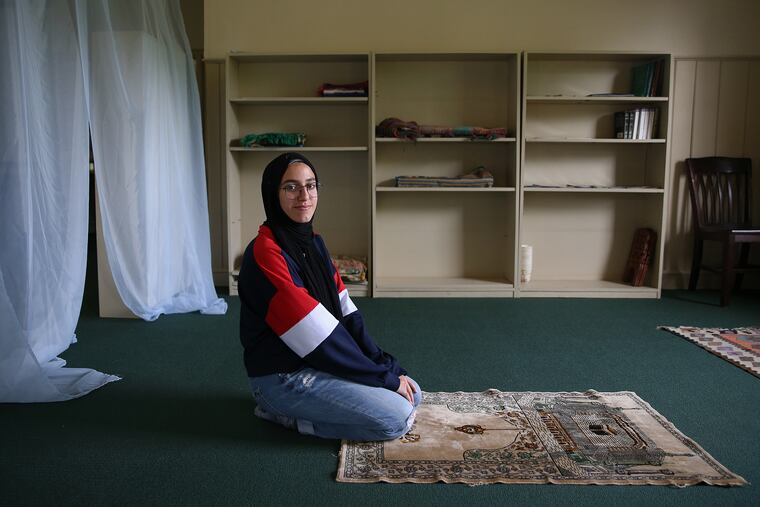 George School senior Saleema Walter, 17, of North Brunswick, N.J., kneels for a portrait in the new prayer space for Muslim students and faculty on the school's campus in Newtown, Pa.