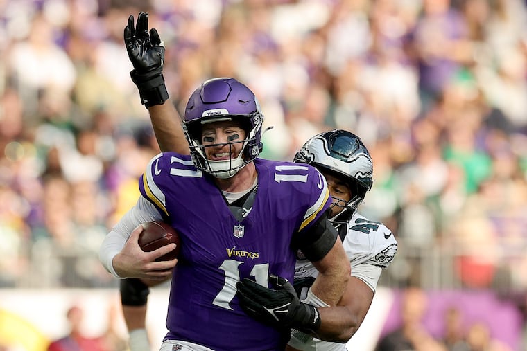Eagles linebacker Patrick Johnson tries to knock the ball out of Minnesota Vikings quarterback Carson Wentz’s hands in fourth quarter on Sunday. Wentz threw a pair of interceptions, including a pick-six, against his former team.