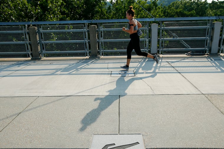 A jogger runs across the Manayunk Bridge between the Manayunk and the Cynwyd Heritage Trails.