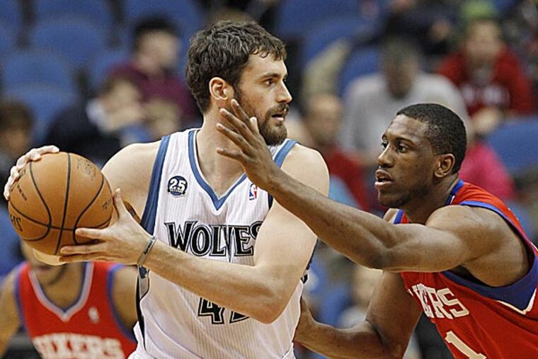 Timberwolves forward Kevin Love looks to drive against 76ers forward Thaddeus Young. (Ann Heisenfelt/AP)