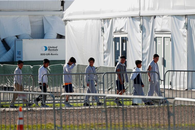 FILE- In this Feb.19, 2019 file photo, children line up to enter a tent at the Homestead Temporary Shelter for Unaccompanied Children in Homestead, Fla. The company that runs the center is Comprehensive Health Services, which is part of Virginia-based Caliburn International Corporation. The chairman of Caliburn International Corp., Thomas J. Campbell, sent a letter Tuesday, March5, to the Securities and Exchange Commission saying it no longer wishes to conduct a public offering. (AP Photo/Wilfredo Lee, File)