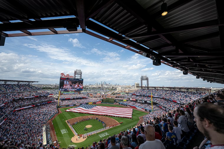 A large American Flag is unfurled following the player introductions prior to the Opening Day Game between the Philadelphia Phillies versus the Colorado Rockies at Citizens Bank Park in Philadelphia, Pa. Monday, March 31, 2025
