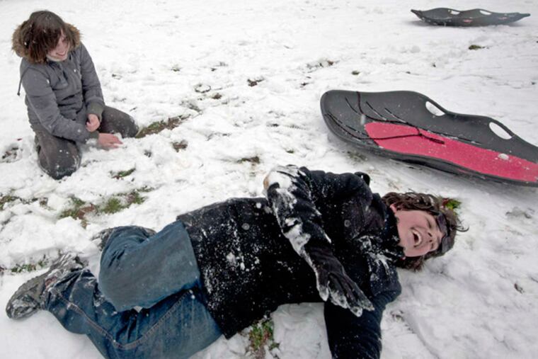 Haddon Heights 14-year-olds Lily Stark (left) and Gabe Lipko frolic in the snow, which accumulated to up to 5 inches in the region Monday.