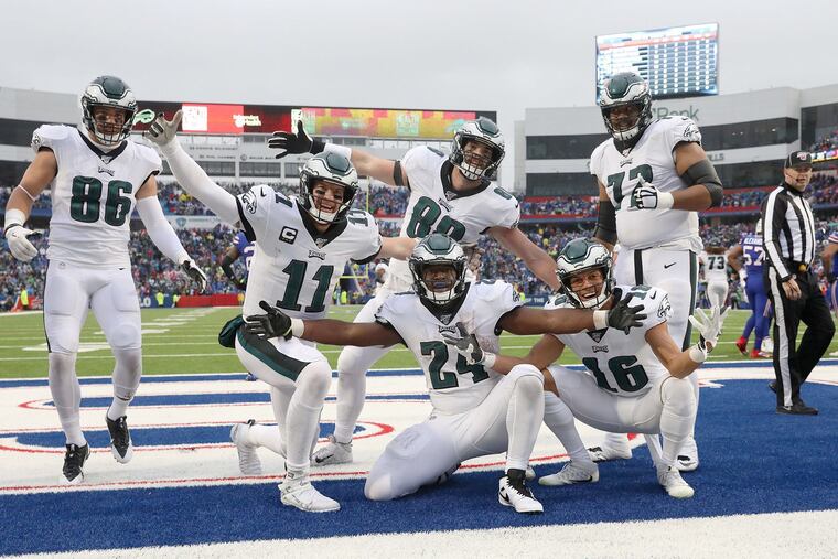 Eagles running back Jordan Howard (24) celebrates with teammates after scoring a fourth-quarter touchdown.