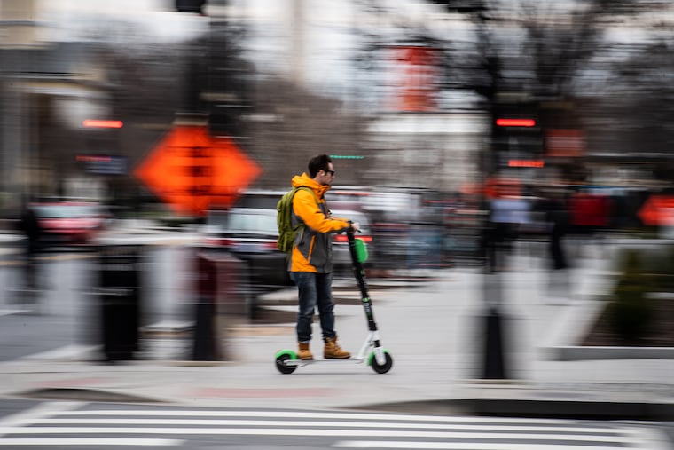 An e-scooter zips along a Washington, D.C., street.