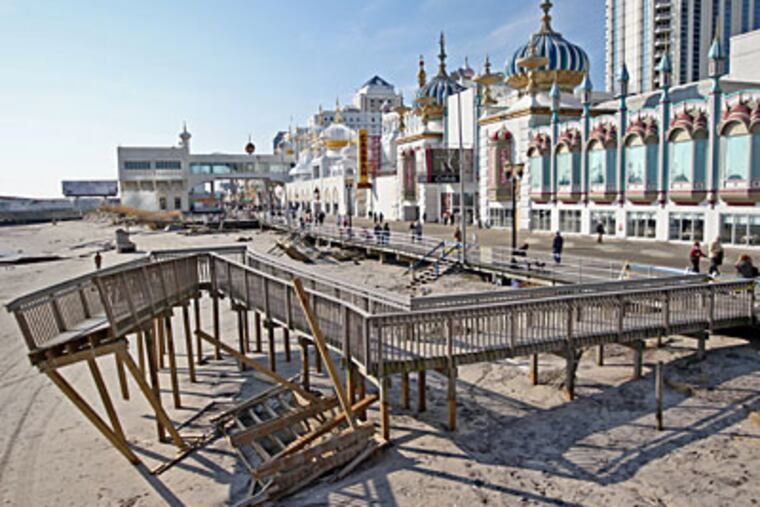 The handicap ramp out to the beach in front of the Taj Mahal Casino in Atlantic City sits in the sand, twisted and broken, after the weekend of heavy weather and surf at the shore. ( Michael Bryant / Staff photographer )