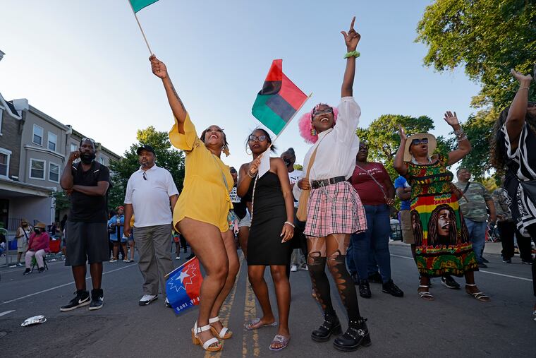 (L-R) Erica Johnson, Shahadah Muhammad and Koda Kirkland (all from Phila.) dance to the music of The Tough Crew during the 2022 Juneteenth Parade & Festival at Malcolm X Park in Phila., Pa. on June 19, 2022.