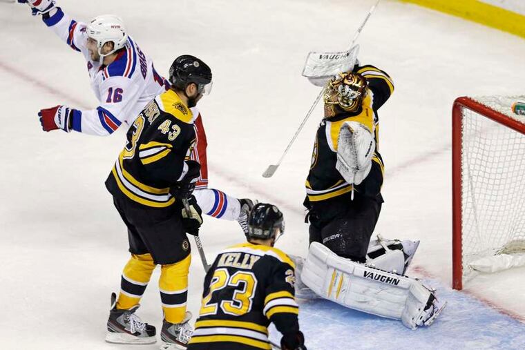 The Rangers' Derick Brassard (upper left) celebrates a goal by teammate Ryan McDonough that beat Bruins goaltender Tuuka Rask. CHARLES KRUPA / Associated Press