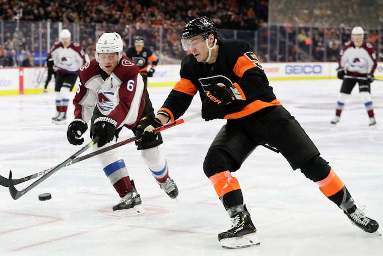With his long reach, Flyers defenseman Phil Myers (right) goes after the puck against Colorado's Erik Johnson in a game last season. Myers signed a three-year contract extension Tuesday.