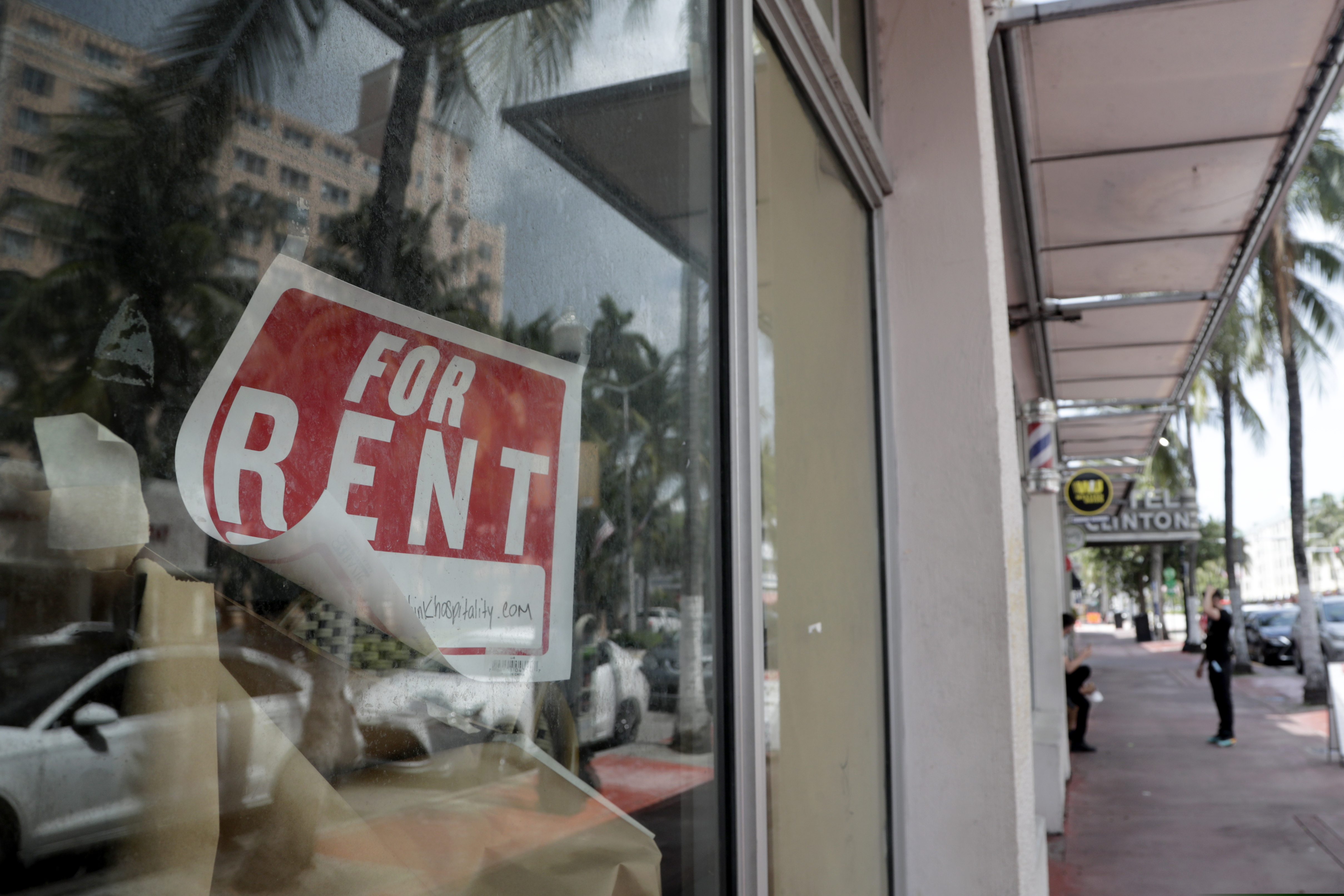 In this July 13 photo, a "For Rent" sign hangs on a closed shop in Miami Beach, Fla.