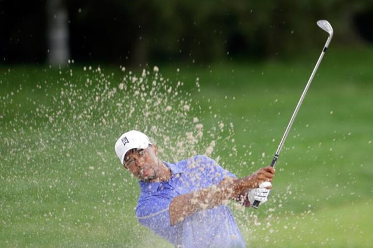 Tiger Woods hits out the bunker at the second hole during the 2013
U.S. Open at the Merion Golf Club East Course on Thursday, June 13,
2013. (Yong Kim/Staff Photographer)