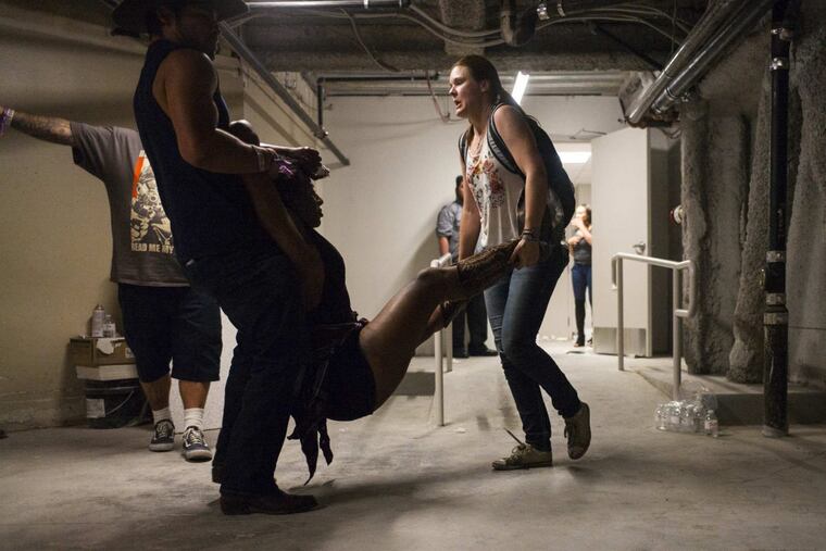 People assist a wounded woman during the mass shooting at the Mandalay Bay Resort & Casino in Las Vegas.