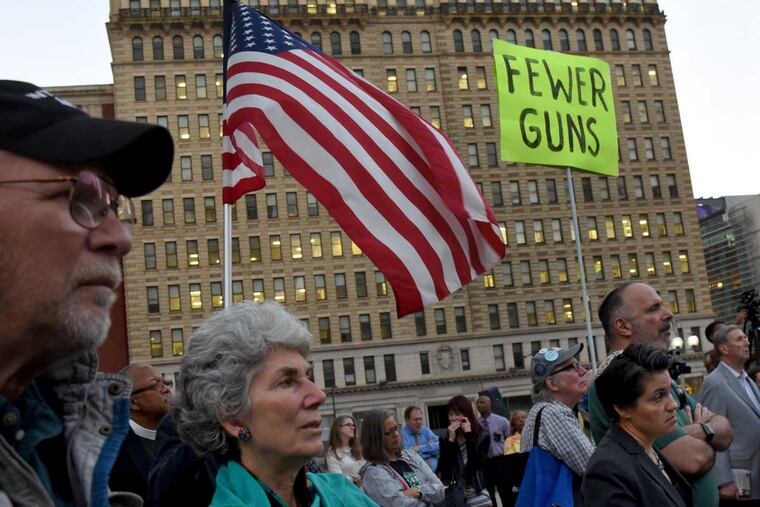 Gregg and Gail Meister (let) of Merchantville, NJ, with Congregation Rodeph Shalom in Philadelphia join political leaders, CeaseFirePA, and churches and synagogues at a vigil in Thomas Paine Plaza for victims of the Las Vegas shootings, Oct. 3, 2017.