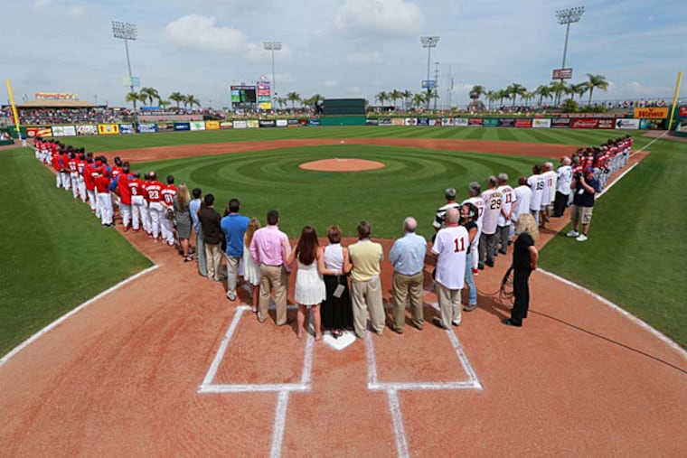 Joni Fregosi, standing on home plate, with family members, former players and coaches. The Phillies and Braves have a moment of silence during a Jim Fregosi tribute at Bright House Field. (David Swanson/Staff Photographer)