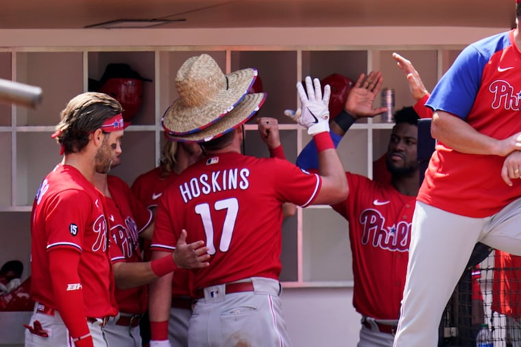 Philadelphia Phillies' Rhys Hoskins (17) wears two home run hats after hitting his second home run of the day during the fifth inning against the San Diego Padres, Sunday, Aug. 22, 2021, in San Diego.