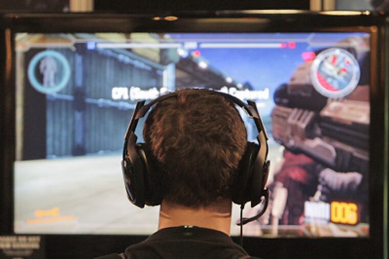 A show attendee plays a video game at the E3 Expo in Los Angeles, Tuesday, June 2, 2009. (AP Photo/Jae C. Hong)