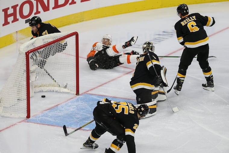 Flyers right winger Cam Atkinson slides and watches the goal he scored against the Boston Bruins during the third period Wednesday at the Wells Fargo Center. Atkinson had a pair of goals in the Flyers' 6-3 win.
