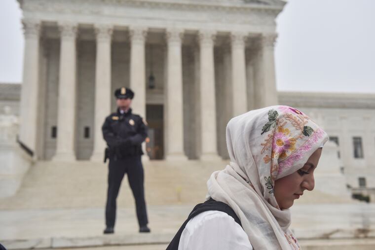 Hanine Mohamed records the events as a crowd protesting President Trump's "Muslim ban" gathers outside the Supreme Court as the justices hear a case involving the travel restrictions on April 25, 2018. The court upheld the ban June of that year.