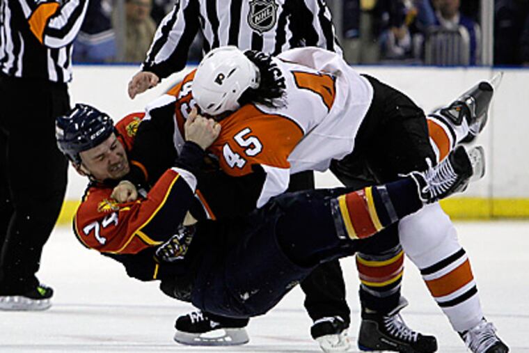 Panthers center Nick Tarnasky (74) fights with Arron Asham (45) in the first period. (AP Photo/Lynne Sladky)