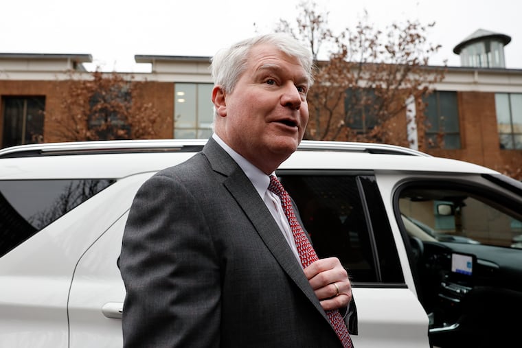 Former union leader John Dougherty ducks into an awaiting car after he was found guilty of nearly all charges in his union embezzlement trial at the federal courthouse in Center City Philadelphia on Thursday.