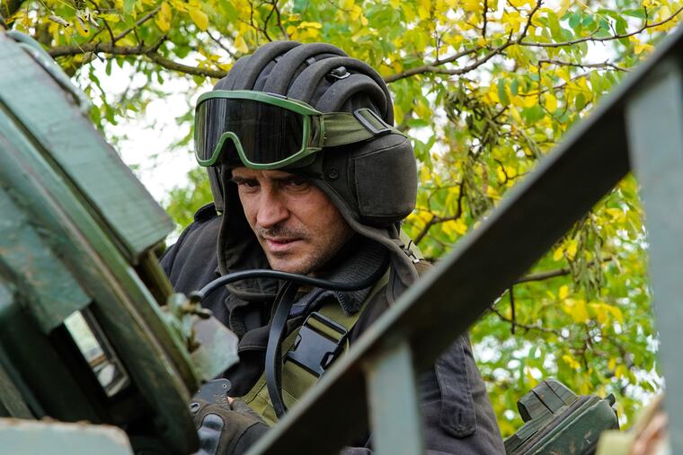 One of the Ukrainian servicemen sits on a T-80 tank that they claimed had been captured from the Russian army, in Bakhmut, Ukraine.
