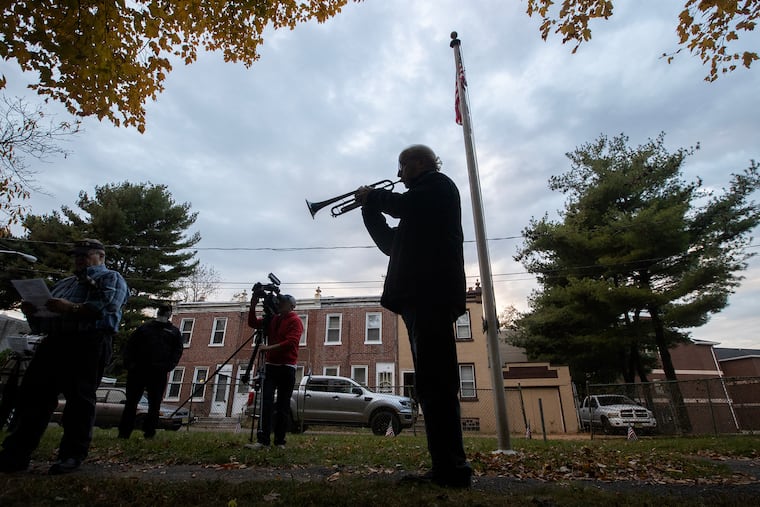 Tony DeLuca plays Taps at the end of a ceremony at Dempsey Butler Cemetery in Camden, N.J. on Nov. 9, 2023. Eight new grave markers were installed in the historic Camden cemetery where soldiers who were members of the U.S .Colored Troop who served in the Civil War are buried. The marble tombstones are weathered and are difficult to read.