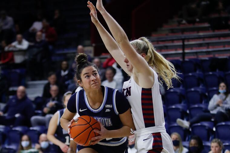 Villanova forward Brianna Herlihy drives to the basket defended by Penn forward Silke Milliman at The Palestra on Monday, November 22, 2021.