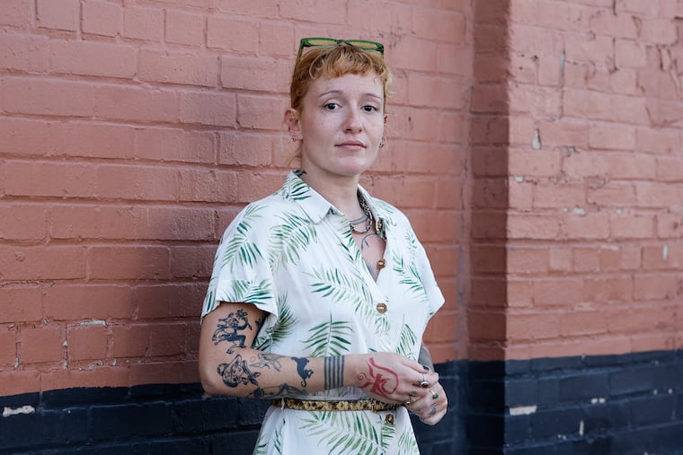 Former UArts instructor Su Güzey stands along the 1700 block of North Fifth Street in the Ludlow neighborhood of Philadelphia on Monday, Aug. 12, 2024. She fears deportation due to the school's unexpected closure.
