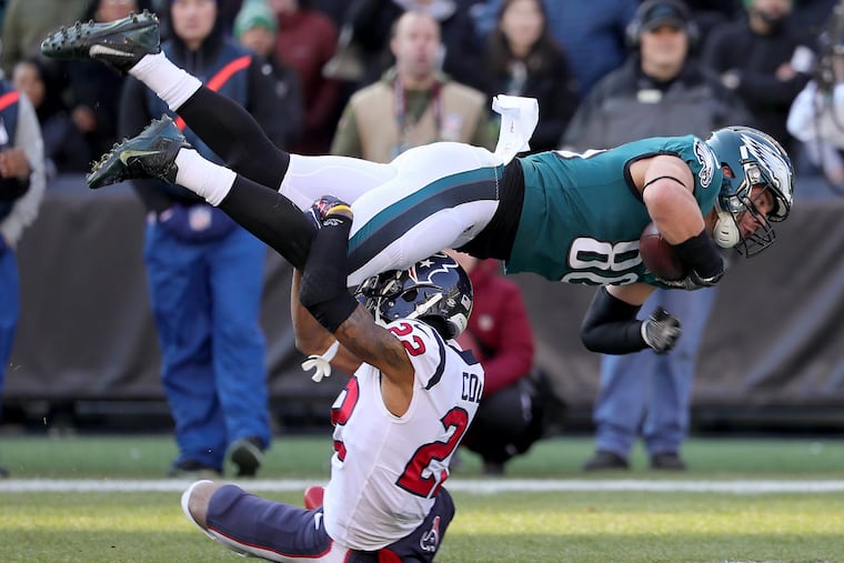 Zach Ertz flies over Texans cornerback Aaron Colvin during the second quarter of Ertz's record-setting day.