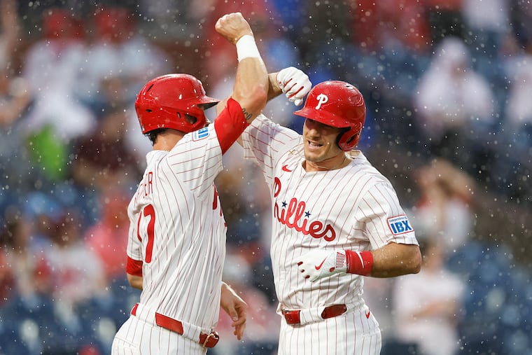 J.T. Realmuto celebrates his three run third inning home run with teammate Max Kepler against the Diamondbacks.