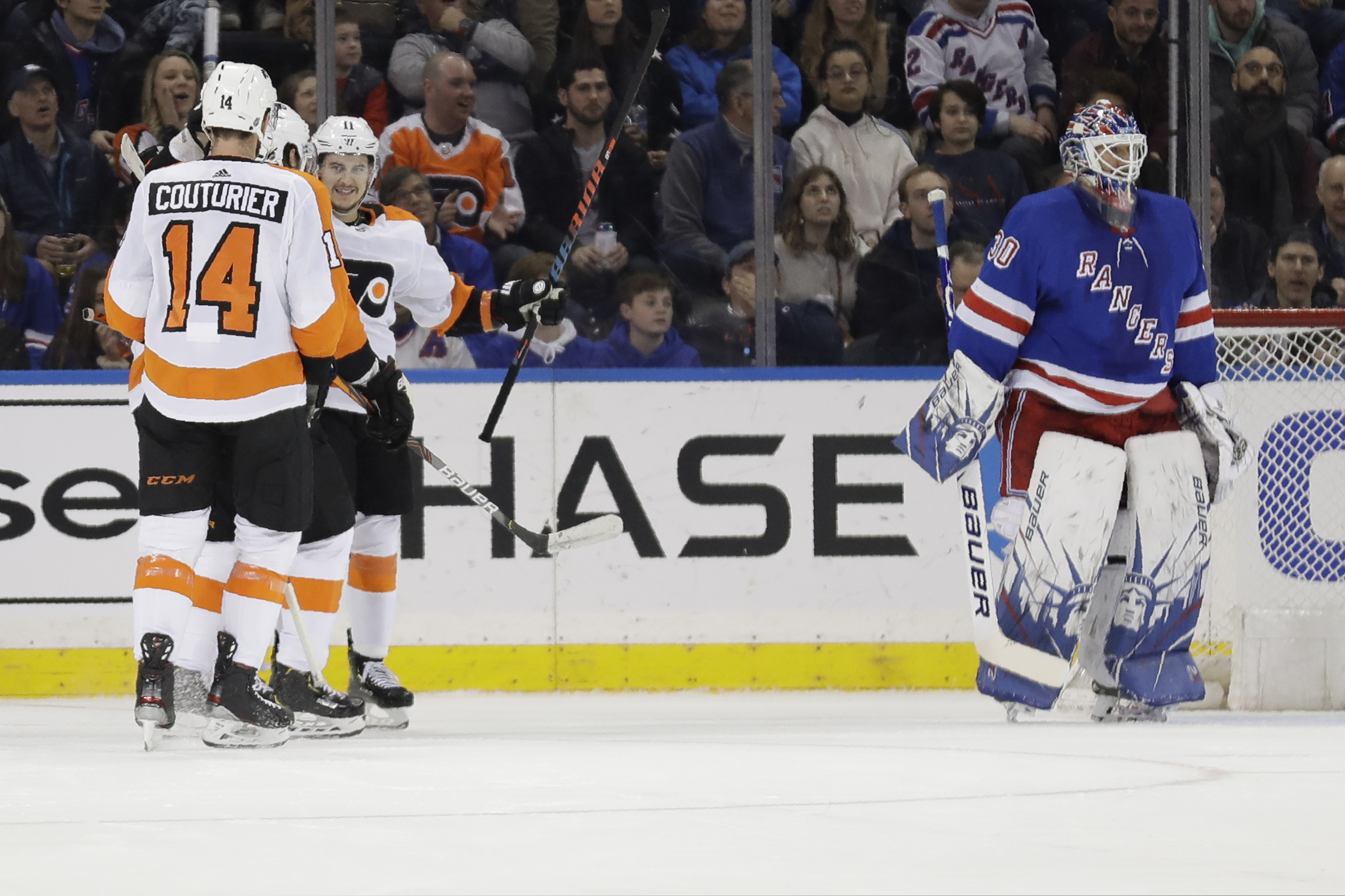 Travis Konecny is congratulated by Sean Couturier after his goal gave the Flyers a 5-1 lead in their 5-3 win over the Rangers on Sunday.