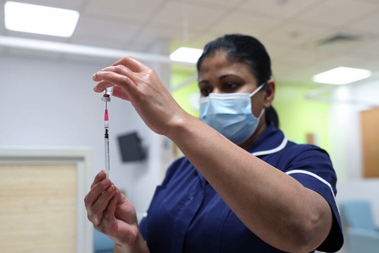 A nurse at the Royal Free Hospital, simulates the administration of the Pfizer vaccine to support staff training ahead of the rollout, in London, Dec. 4, 2020. The United Kingdom has already approved use of the vaccine and expects to begin administering doses Dec. 8. It will start by vaccinating people aged 80 above, some nursing homes staff and other high-risk health workers.