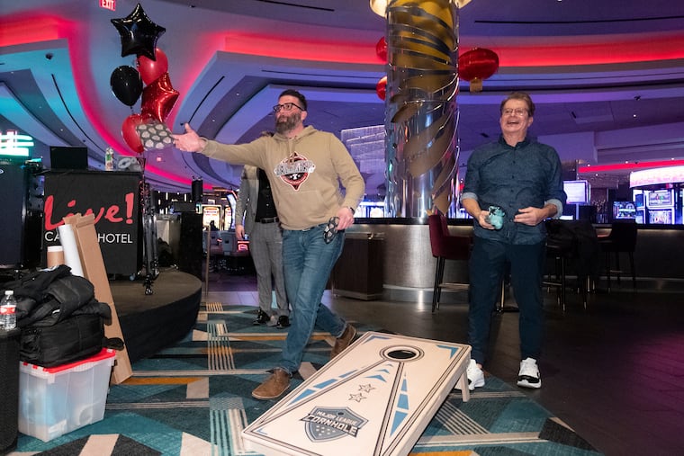 The Philadelphia Bell-Ringers will be a part of the newly founded league called Major League Cornhole. Bell-Ringers co-owner Zeb Campagna (left) and radio host and blogger Mike Missenelli play a game of cornhole at the team's signing announcement at Live! Casino in South Philadelphia on Friday.